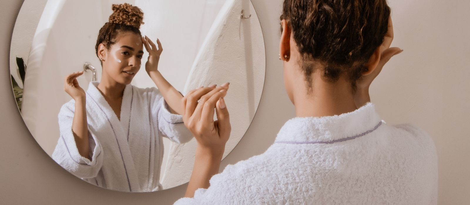 woman close up skin pores mirror